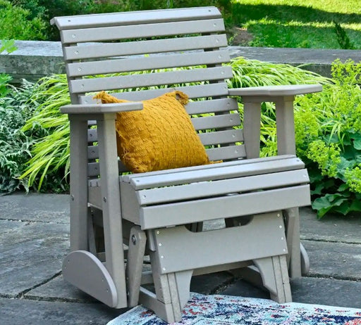 Glider Chair on stone patio with orange pillow
