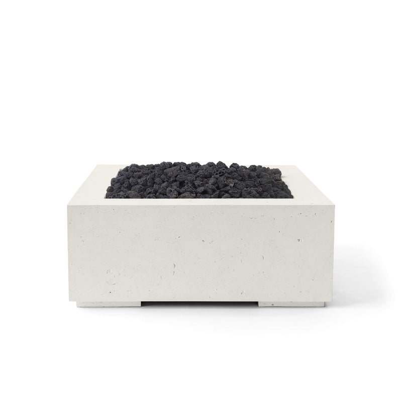 32-inch Alea concrete and limestone fire pit with black lava rocks s on a white background.  