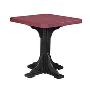 Square table with red top and black base on a white background