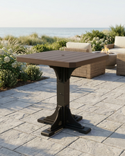 Outdoor patio table on a stone patio with garden and ocean view