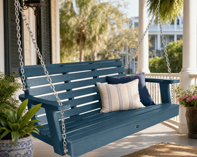 Sequoia nantucket blue 4' swing on a porch with lush plants and flowers.  
