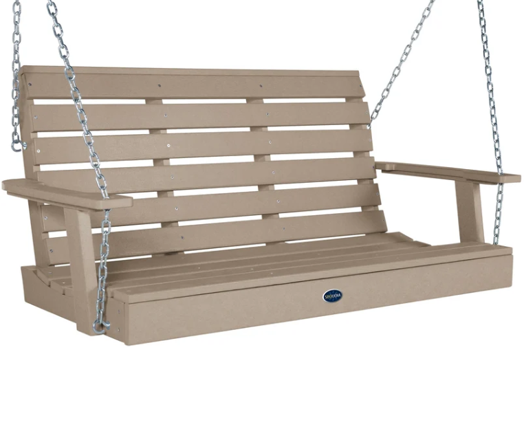A slatted porch swing bench in a warm taupe-beige color, suspended by silver metal chains, shown against a plain white background.