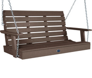 A brown slatted porch swing bench with silver hanging chains, shown on a plain white background. A small oval brand badge on the front reads POLYWOOD.