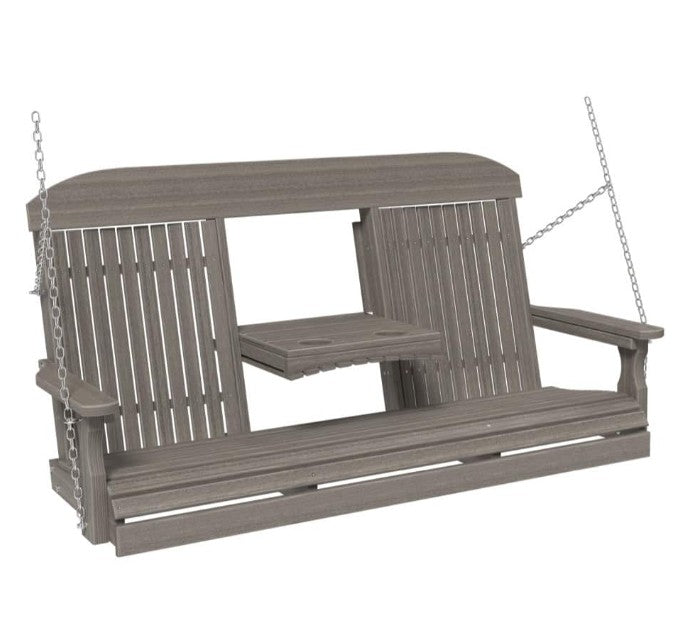 A gray slatted porch swing bench with a small attached side table, suspended by metal chains against a plain white background.
