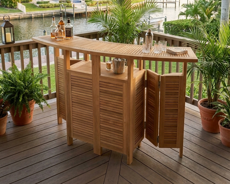 Anderson Teak Altavista Folding Bar Table on a wooden patio overlooking a intercoastal scene and views of a waterway.  
