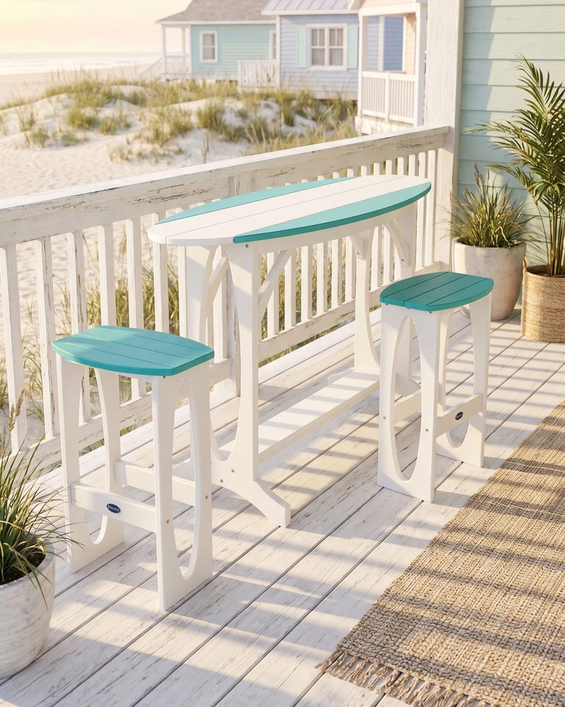 Outdoor furniture set with turquoise seats and white frames on a deck with beach view.