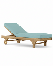 Capri teak lounger with mineral blue cushion on white background. 