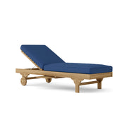 Capri teak lounger with navy cushion on a white background