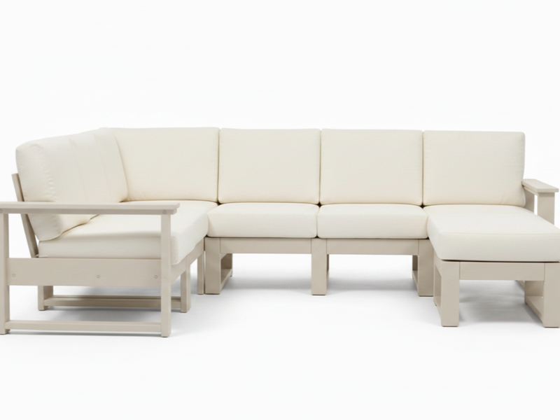 A modern outdoor sectional sofa set with cream-colored cushions and a light beige frame, including a left-facing chaise lounge, three center seat cushions, and a right-facing chaise ottoman, shown on a white background.