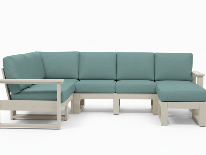 A modern outdoor sectional sofa with light sage green cushions and a light beige frame, shown against a plain white background.