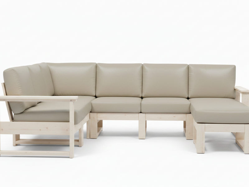 A light beige outdoor sectional sofa with a natural wood frame, featuring four back cushions, a left armchair attachment, and a right chaise attachment, shown against a plain white background.