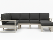 A modern outdoor sectional sofa with dark gray cushions and a light beige frame, shown against a plain white background.