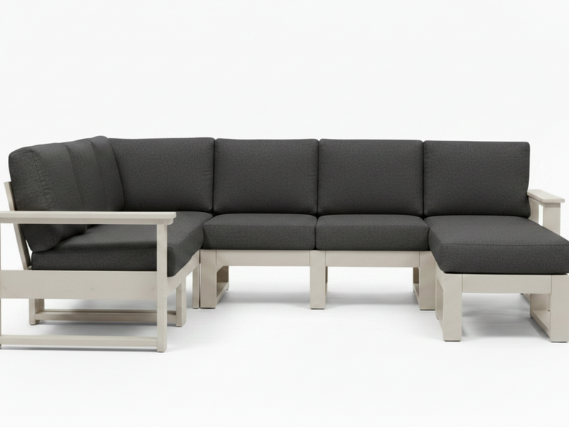 A modern outdoor sectional sofa with dark gray cushions and a light beige frame, shown against a plain white background.