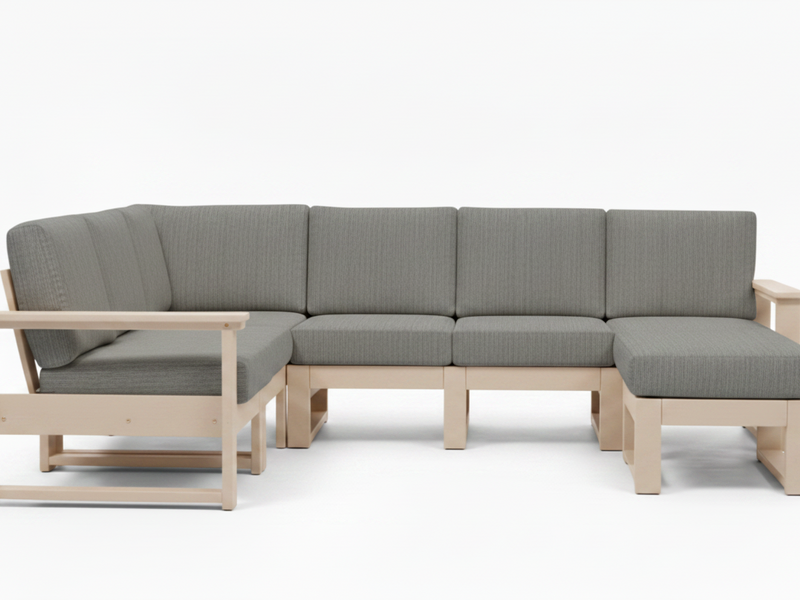 A modern sectional sofa with light natural wood frames and textured gray fabric cushions, shown against a plain white studio background.