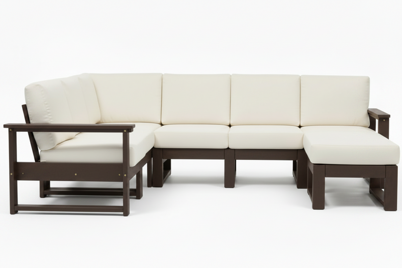 A modern outdoor sectional sofa with cream-colored cushions and a dark brown frame, including a chaise lounge on the left and a matching ottoman, shown on a white background.