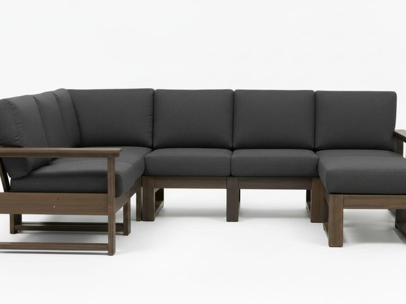A modern outdoor sectional sofa with dark gray cushions and a medium brown wooden frame, shown against a plain white studio background.