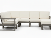 An outdoor sectional sofa set with cream-colored cushions and weathered gray-brown wooden frames, shown against a plain white studio background.