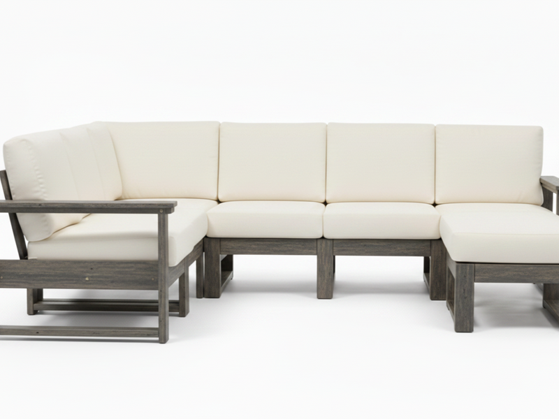 An outdoor sectional sofa set with cream-colored cushions and weathered gray-brown wooden frames, shown against a plain white studio background.