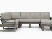 A modern outdoor sectional sofa with light taupe cushions and weathered gray-brown wooden frames, shown against a plain white studio background.