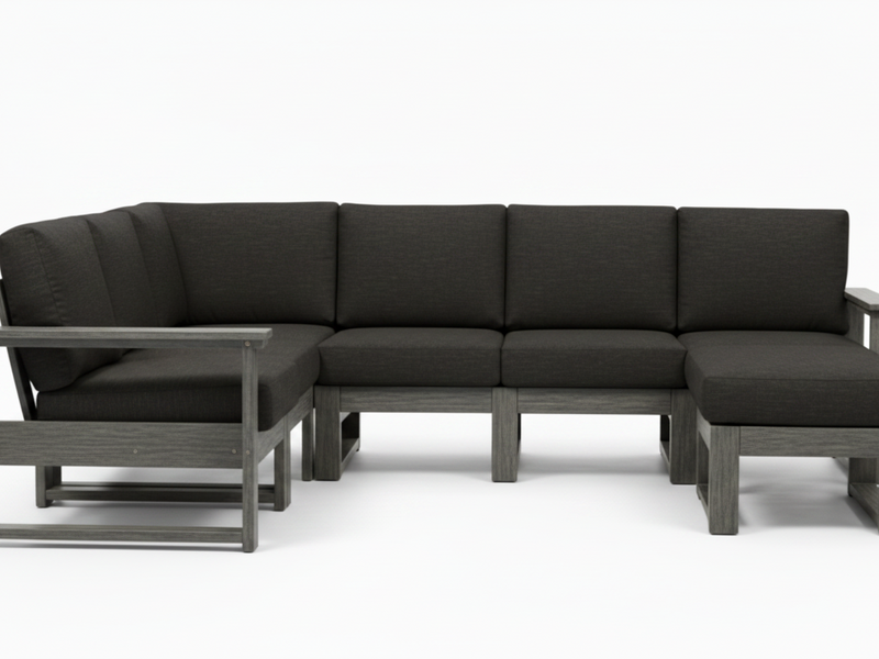 A modern outdoor sectional sofa with dark charcoal gray cushions and a weathered gray frame, shown against a plain white background.