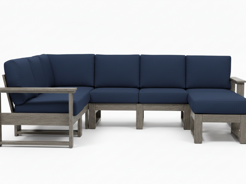 A 5-piece outdoor sectional sofa with thick navy blue cushions and a weathered gray wood frame, shown against a plain white background.