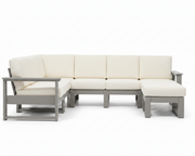 An outdoor sectional sofa with cream-colored cushions and a gray frame, shown against a solid white background.