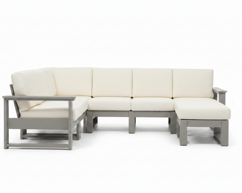 An outdoor sectional sofa with cream-colored cushions and a gray frame, shown against a solid white background.