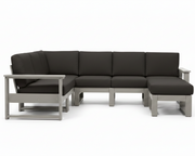 A modern outdoor sectional sofa with dark charcoal gray cushions and a light gray frame, shown against a plain white background.