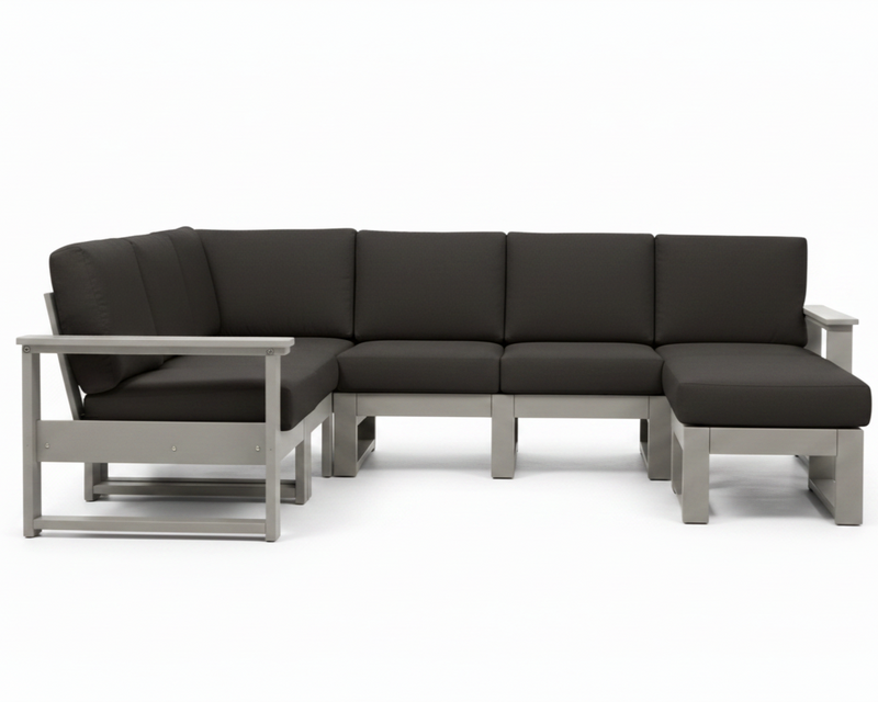 A modern outdoor sectional sofa with dark charcoal gray cushions and a light gray frame, shown against a plain white background.