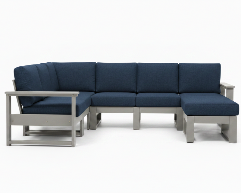 A modern outdoor sectional sofa with dark blue textured cushions and a light gray frame, shown against a plain white background.