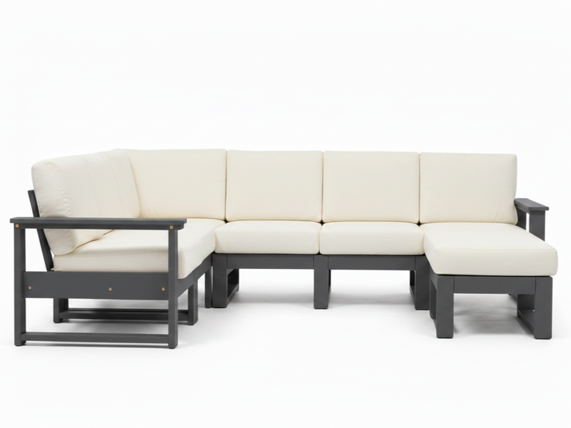 A modern outdoor sectional sofa with cream-colored cushions and a dark gray frame, including a chaise lounge on the left and a right-facing ottoman, shown on a white background.