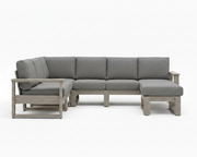 A modern outdoor sectional sofa with light gray fabric cushions and a weathered light gray wood frame, shown against a plain white background.
