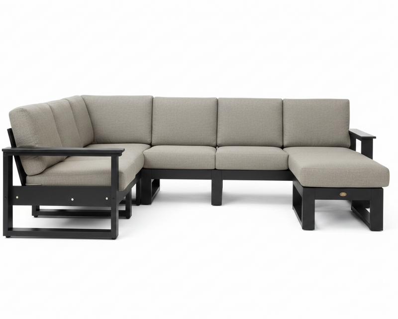 A modern outdoor sectional sofa with light beige textured cushions and a black frame, featuring a left-facing chaise lounge and a right-facing chaise ottoman, shown against a plain white background.