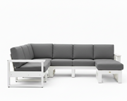 A modern outdoor sectional sofa with a white frame and dark gray cushions, shown against a plain white background.