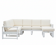 A modern outdoor sectional sofa set with cream-colored cushions and a white frame, including a chaise lounge chair, a four-seat sofa, and a matching ottoman, shown against a plain white background.