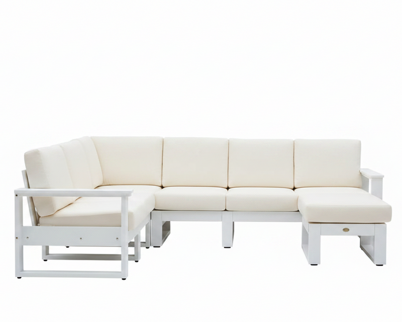 A modern outdoor sectional sofa set with cream-colored cushions and a white frame, including a chaise lounge chair, a four-seat sofa, and a matching ottoman, shown against a plain white background.