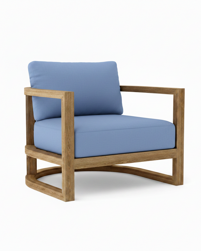 Junus teak armchair with cast ocean cushion on a white background.  