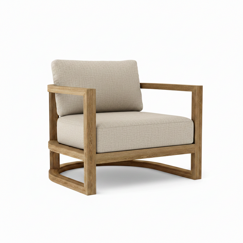 Junus teak armchair with cast silver cushion on a white background.  