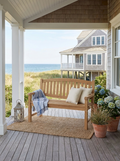 Anderson Teak Kingston 2-seater bench on a covered patio with coastal and ocean views.  
