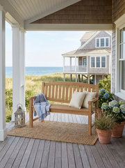 Anderson Teak Kingston 2-seater bench on a covered patio with coastal and ocean views.  