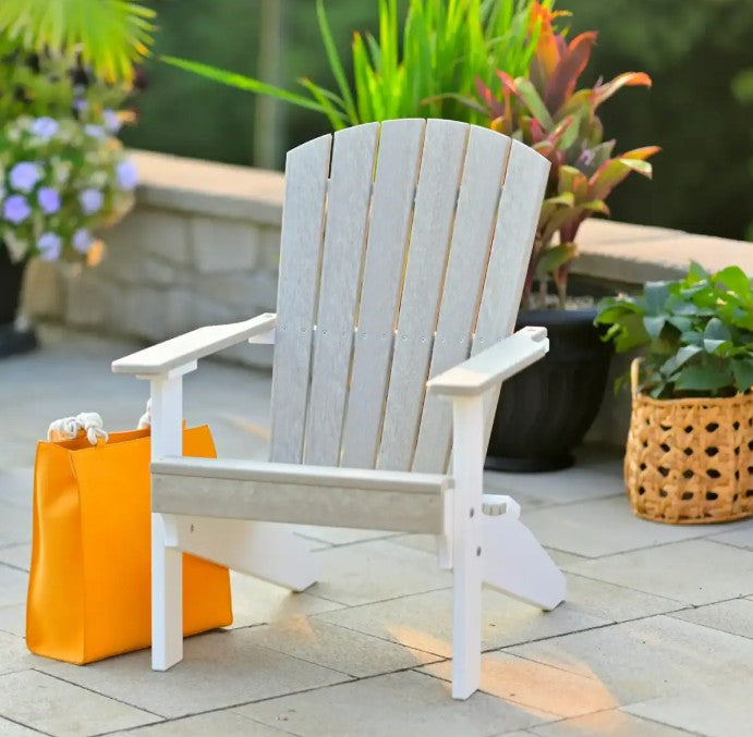 Birch and white Adirondack chair on a patio with potted plants and an orange bag.