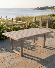 Outdoor table on a stone patio with a scenic ocean view.