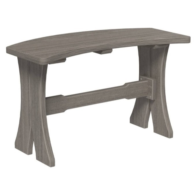 A curved bench with a weathered gray finish, featuring a thick seat, curved legs, and a central support beam, shown against a plain white background.