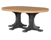 An oval outdoor dining table with a light tan composite top and a black trestle-style base, shown on a plain white background.
