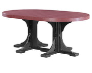 An oval outdoor dining table with a reddish-brown slatted top and a black trestle-style base, shown on a plain white background.