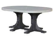 An oval outdoor dining table with a light gray slatted top and a black trestle-style base, shown on a plain white background.