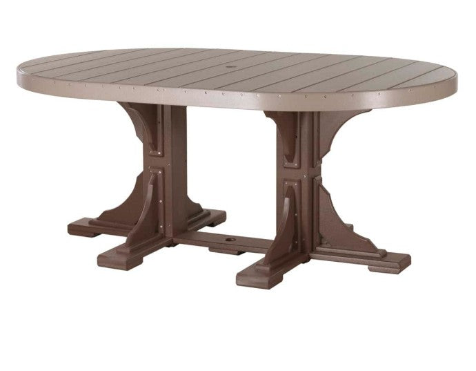 An oval outdoor dining table with a light taupe slatted top and a dark brown trestle-style pedestal base, shown on a plain white background.