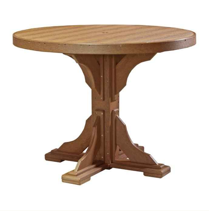 A round outdoor table made of weathered brown composite lumber, featuring a pedestal base with decorative brackets and four legs, shown on a solid white background.