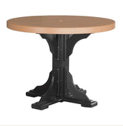 A round outdoor dining table with a light brown composite wood top and a black pedestal base, shown against a plain white background.