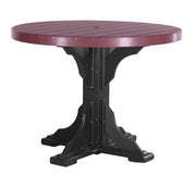 A round outdoor dining table with a dark reddish-brown slatted top and a black pedestal base, shown on a plain white background.